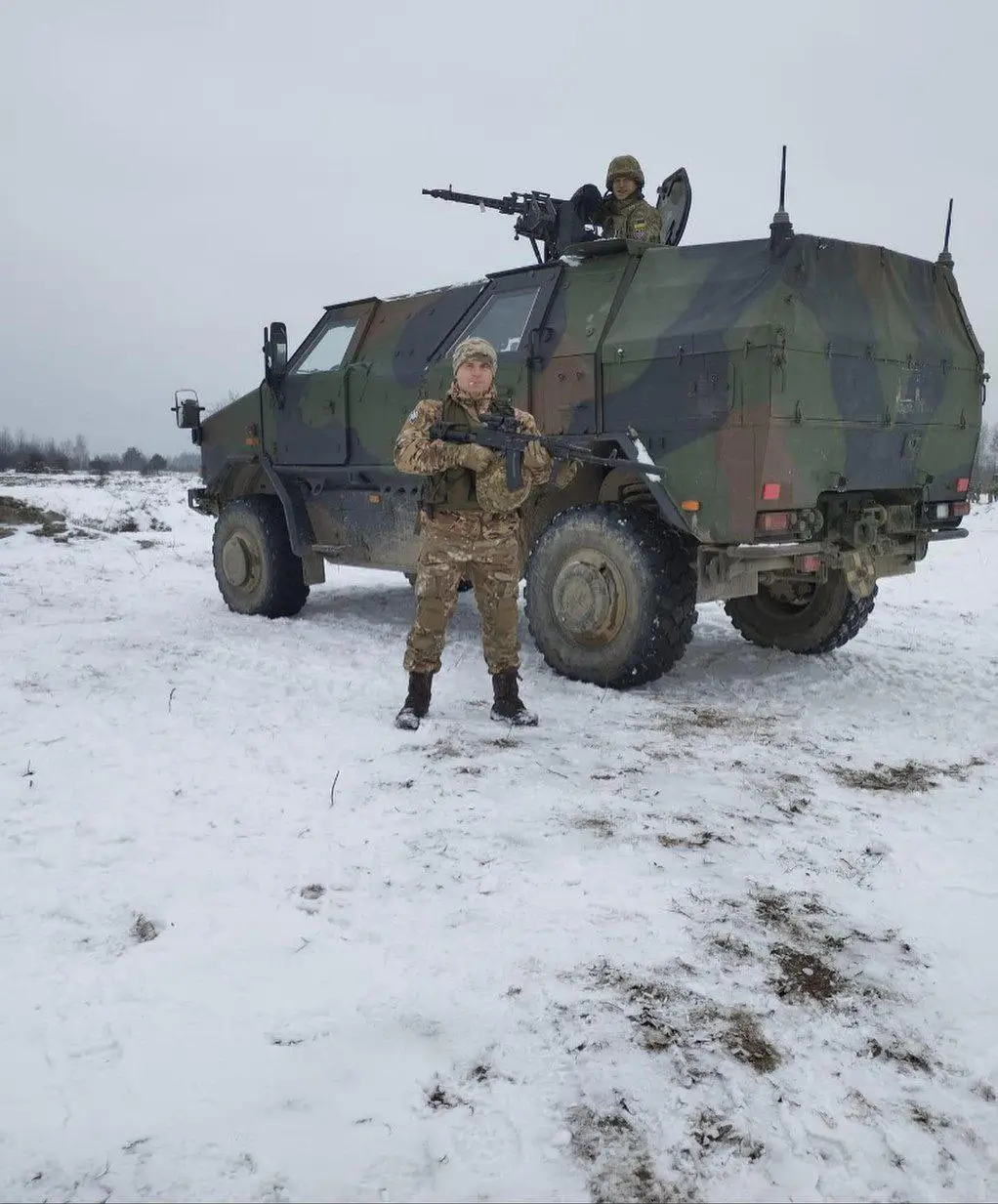 Two Ukrainian soldiers with an ATF Dingo 2 and mounted MG3