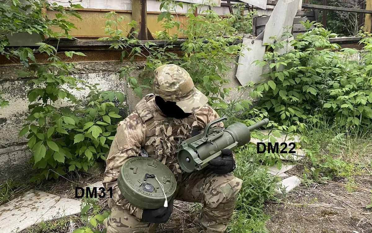 Ukrainian soldier posing with a DM22 and DM31 anti-tank mine