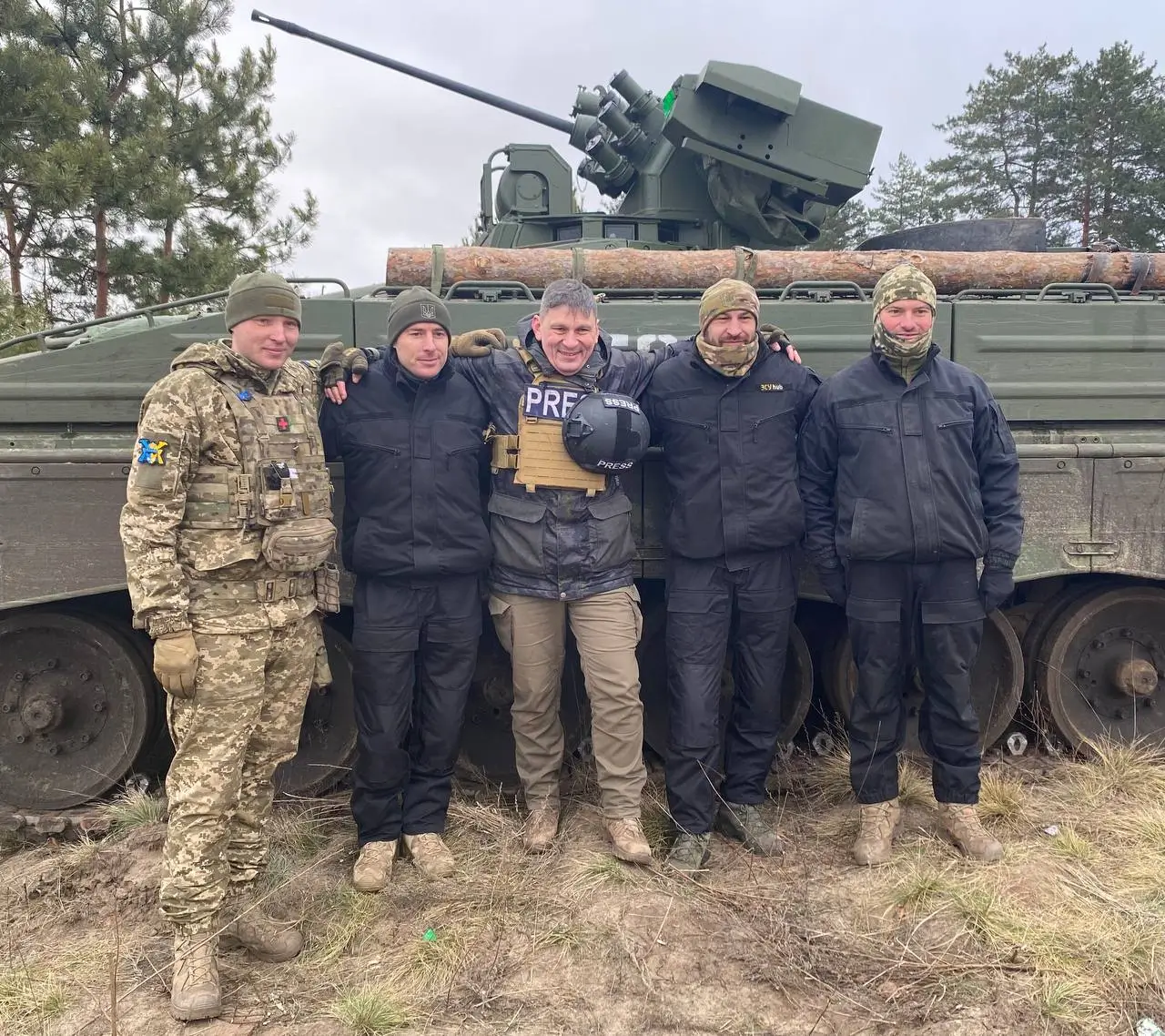 Ukrainian soldier together with a press team in front of a Marder 1A3