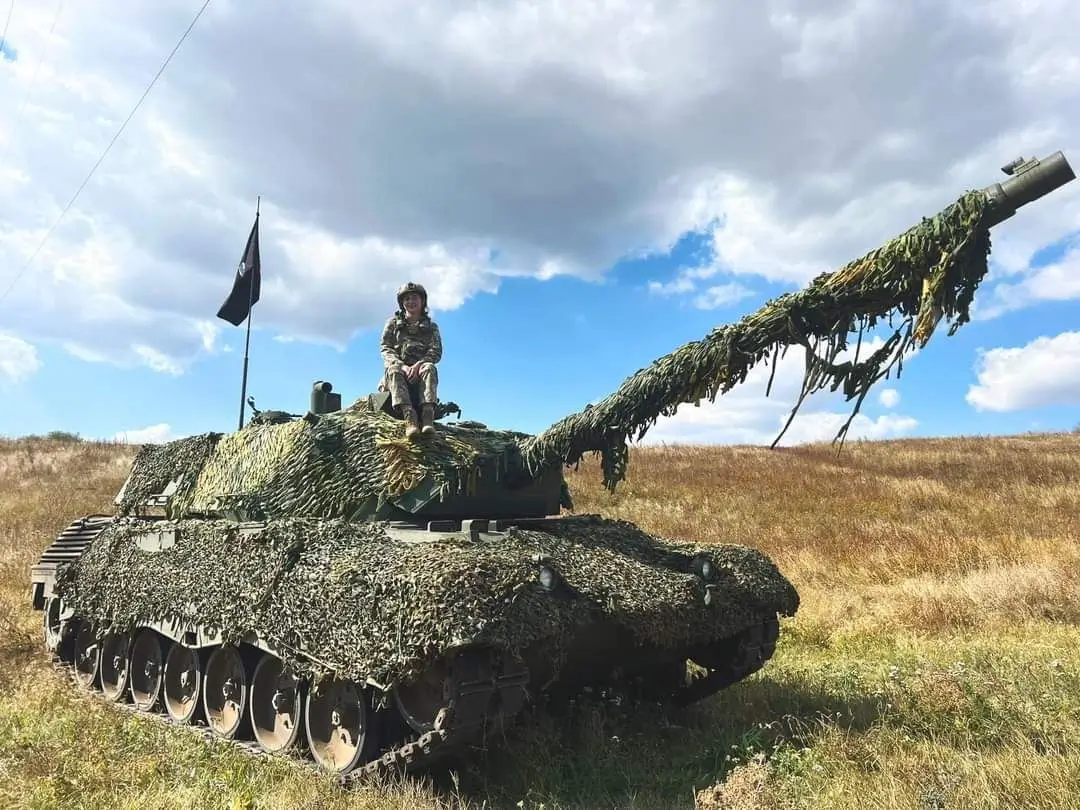 Ukrainian reporter sitting on a Leopard 1A5