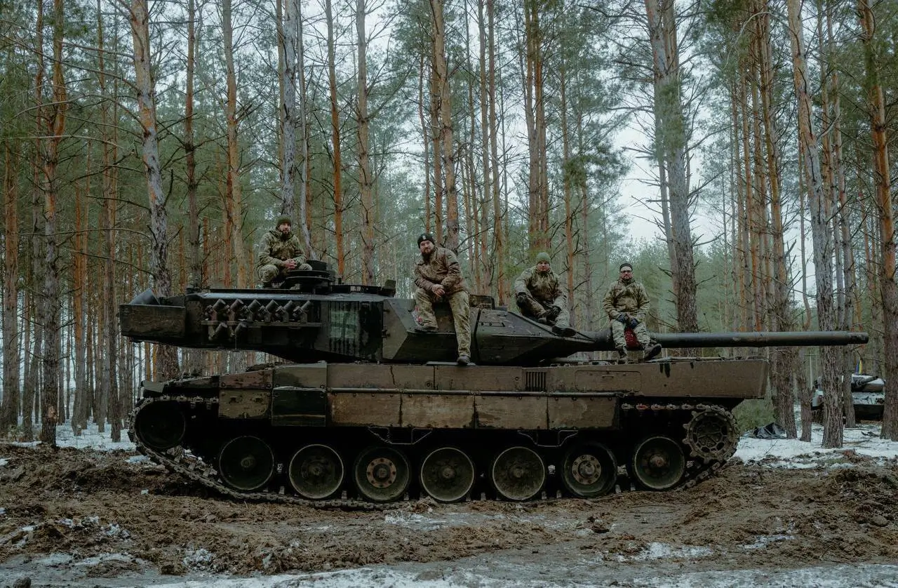 Ukrainian soldiers on top of a Leopard 2A6