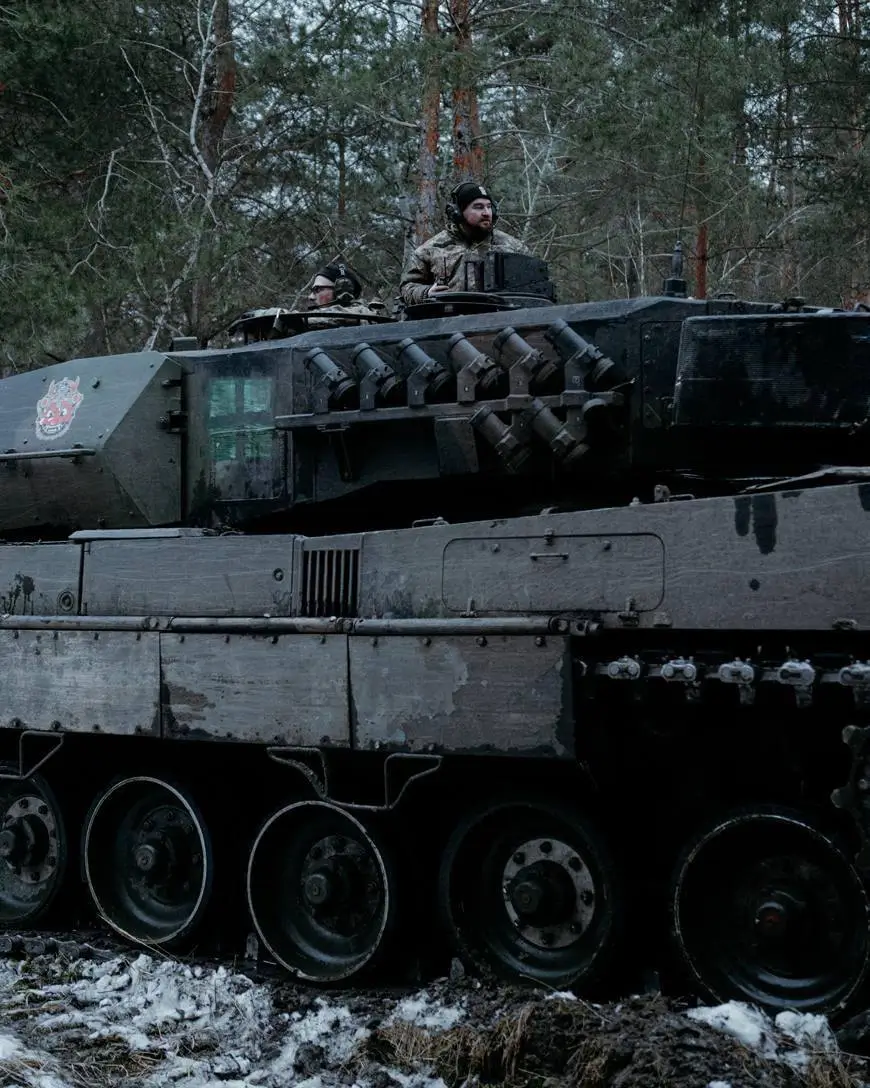 Ukrainian soldiers on top of a Leopard 2A6