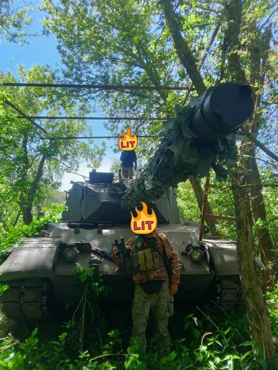 Ukrainian soldiers are posing with a Leopard 1A5