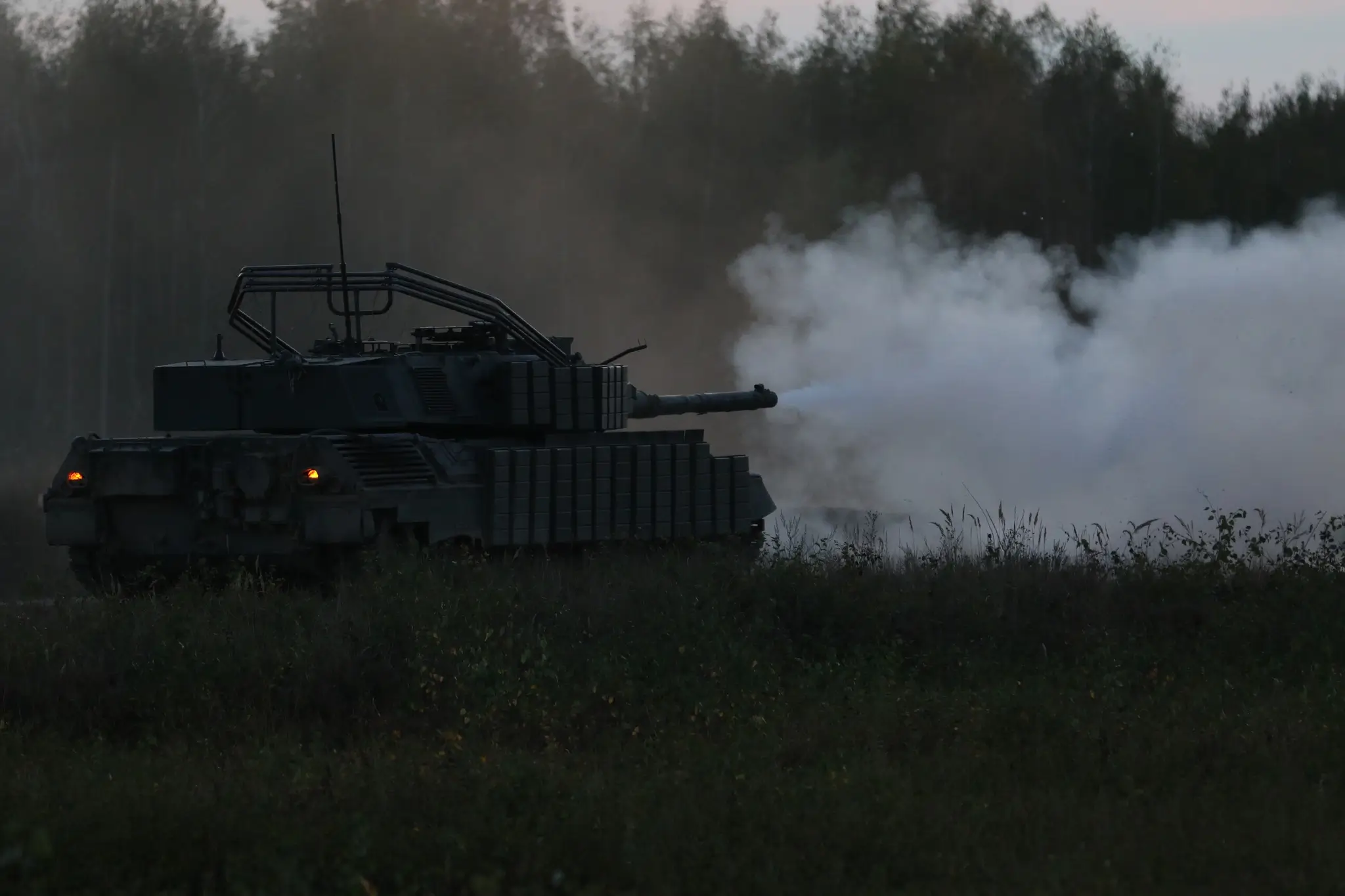 Leopard 1A5 with plenty of additional reactive armour and an installation for a drone net during a shooting exercise