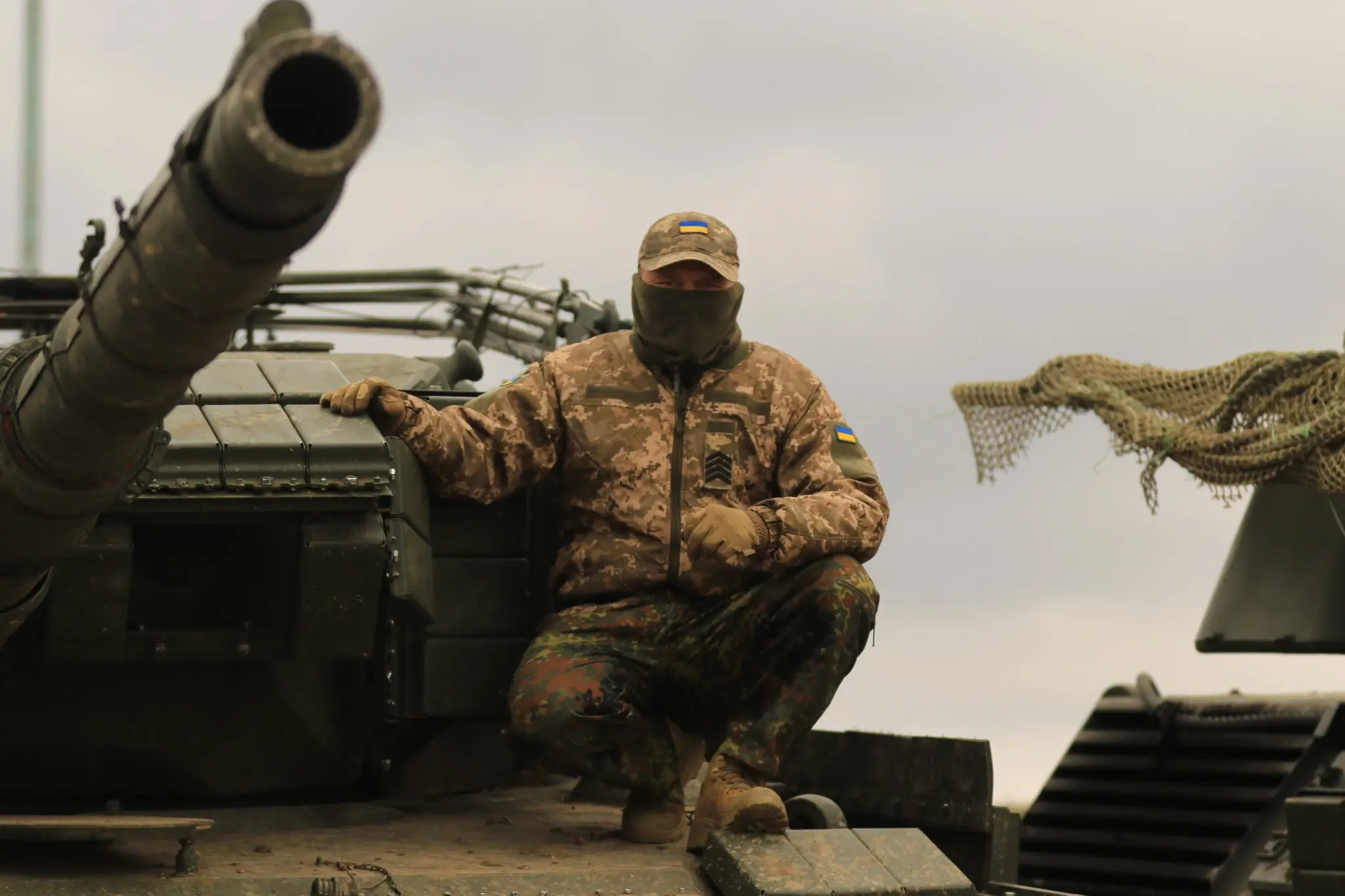 A soldier sitting on top of a Leopard 1A5