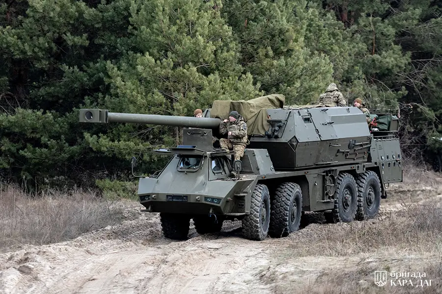Ukrainian soldiers sitting on top of a Zuzana 2