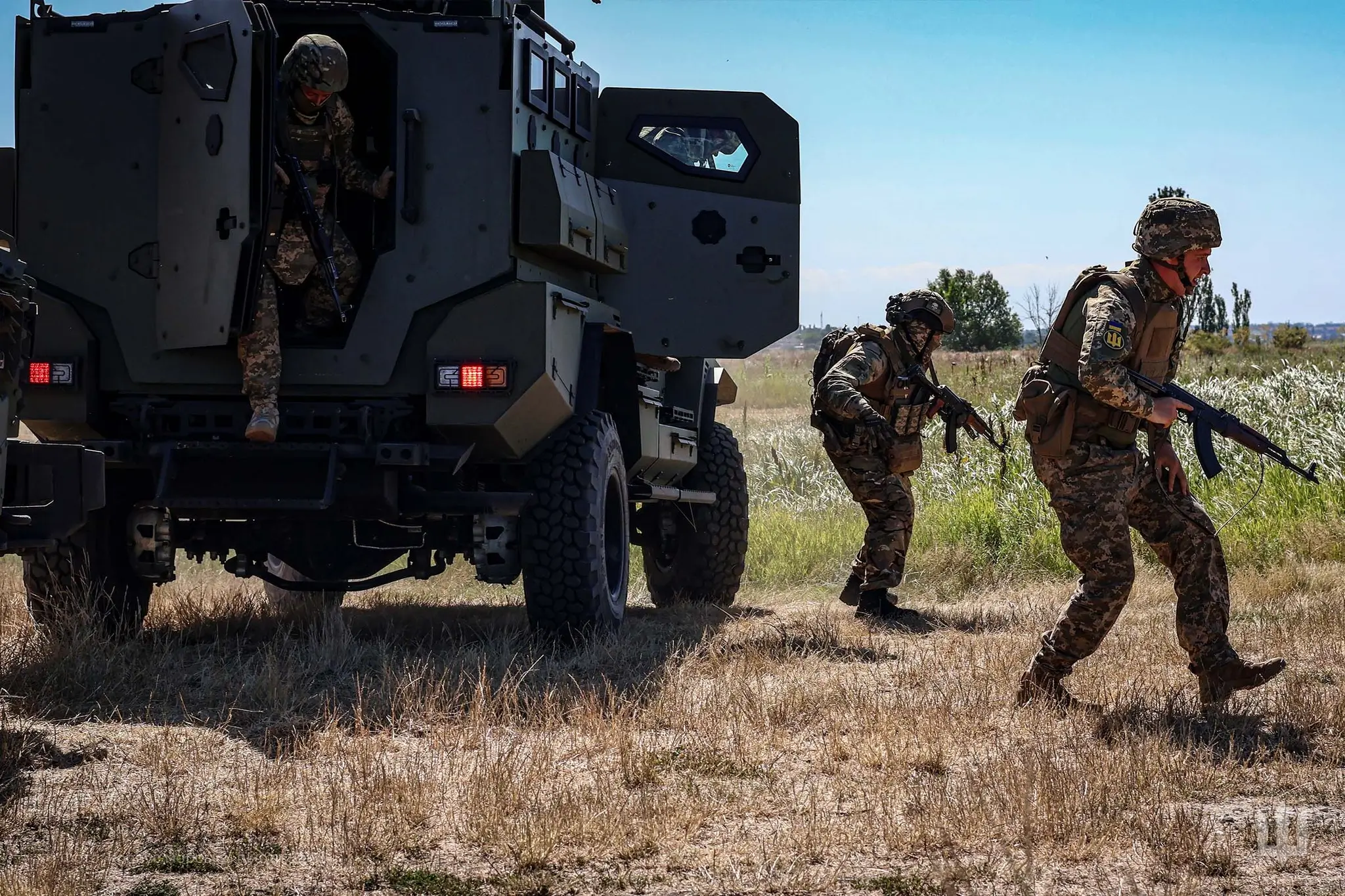 Ukrainian soldiers step out of an FFG APC during a training exercise