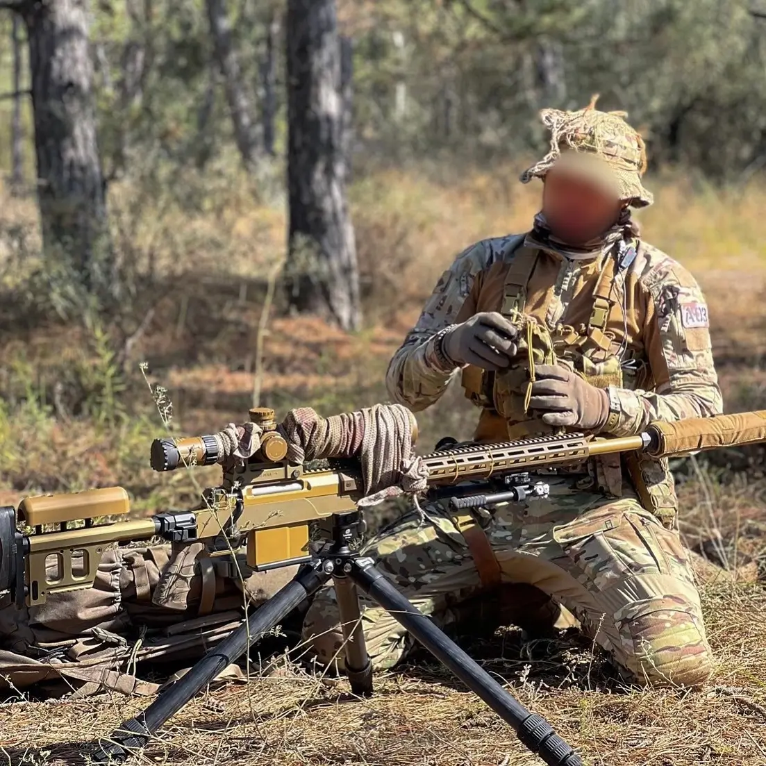 Ukrainian SOF sits behind an HLR 338 precision rifle