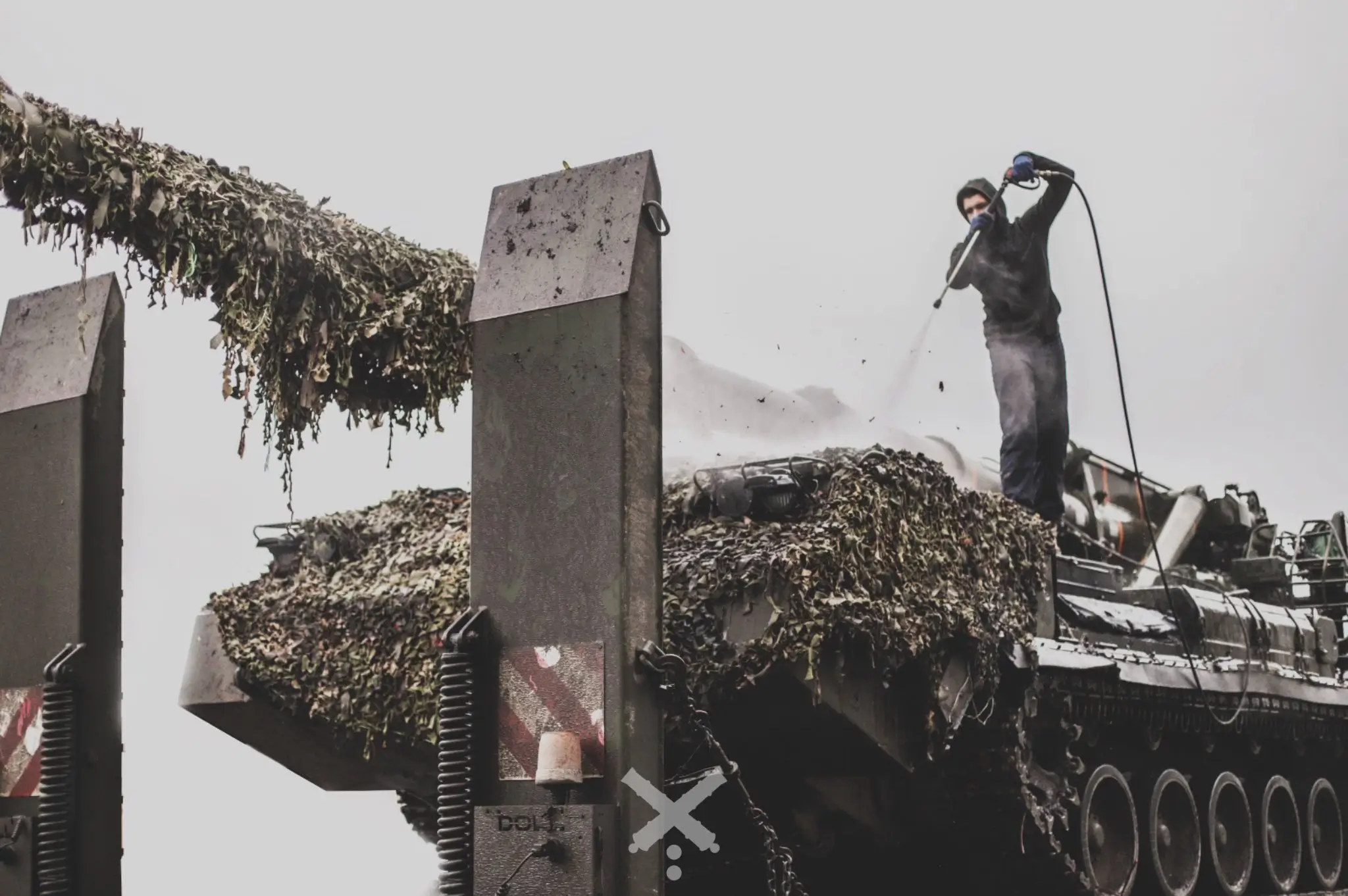 2S7 Pion self-propelled artillery system is being serviced on top of a HX81 tank transporter