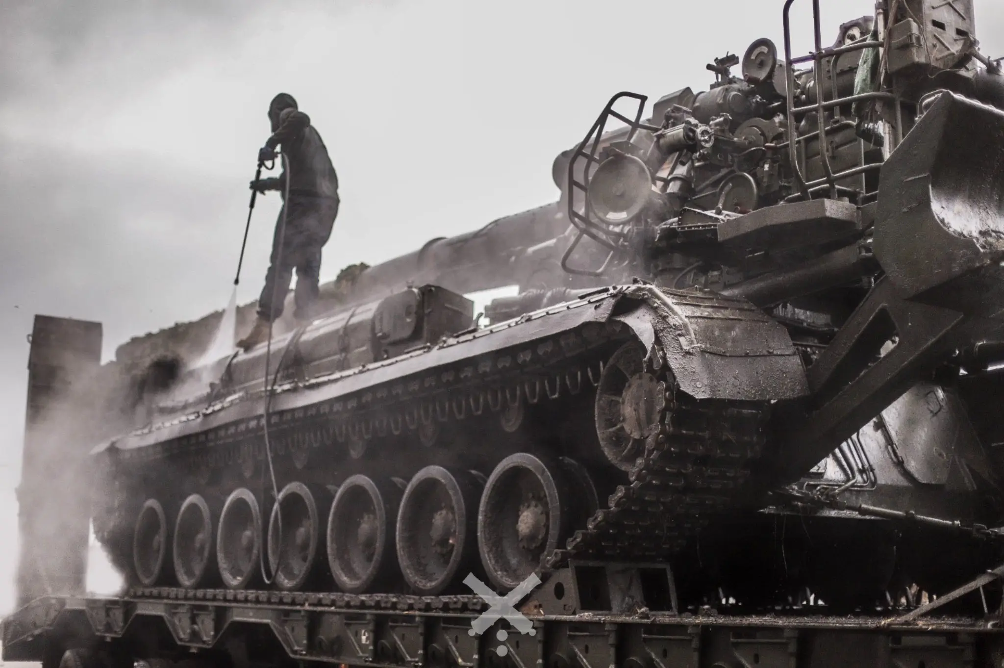 2S7 Pion self-propelled artillery system is being serviced on top of a HX81 tank transporter