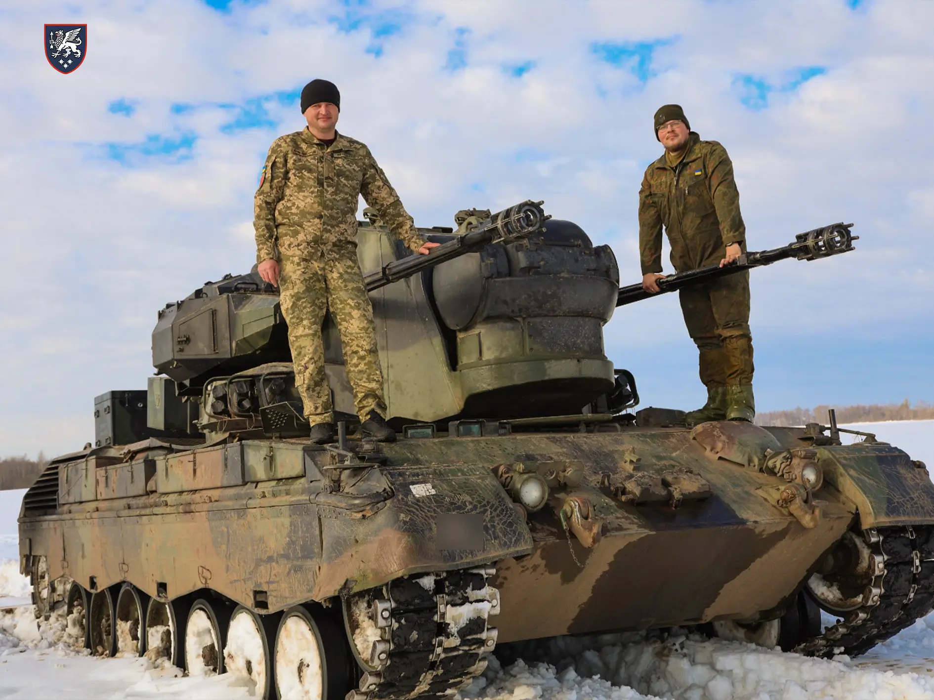Soldiers stand on top of a Cheetah SPAAG