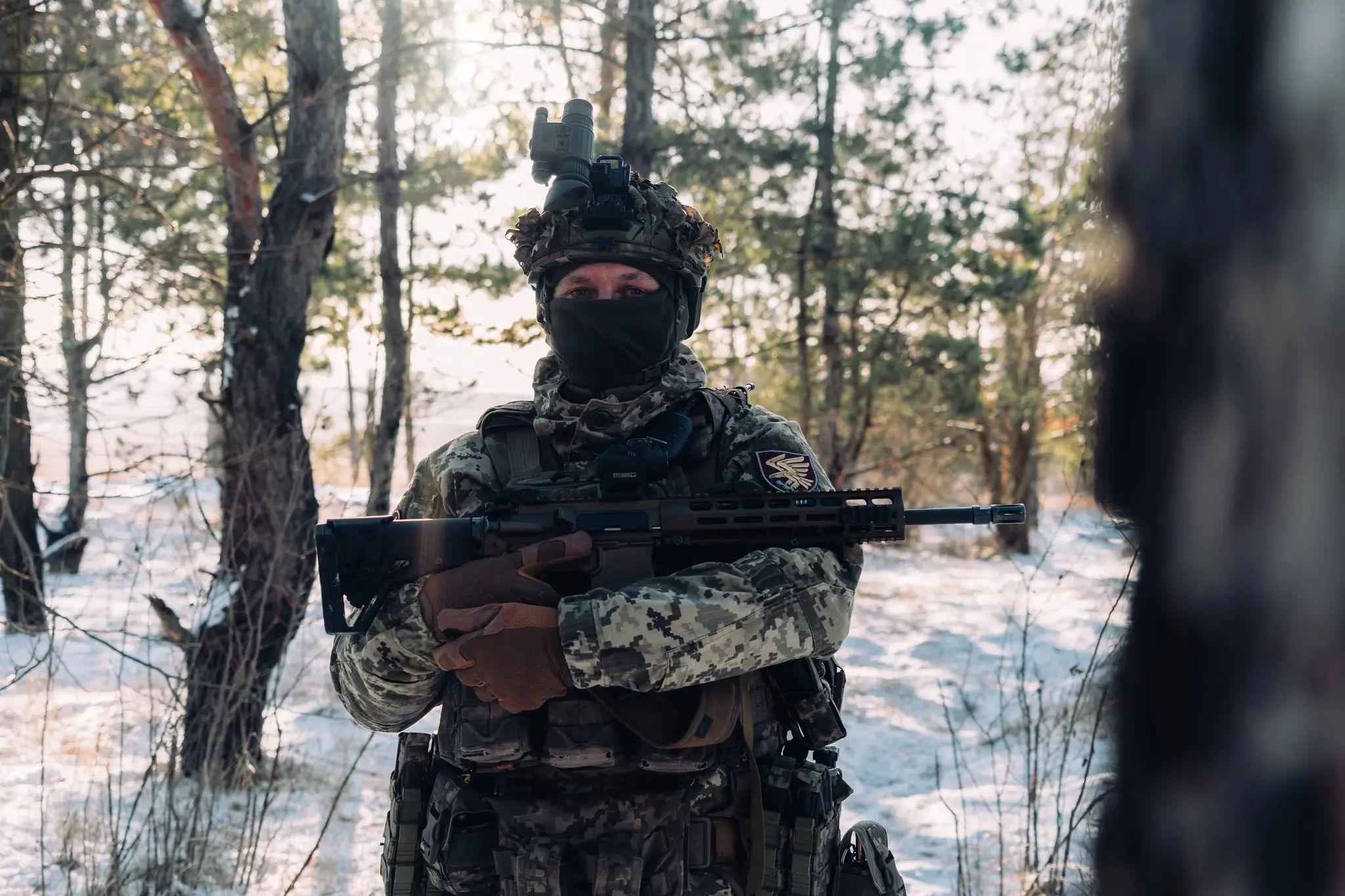 Soldier together with an MK 556 assault rifle