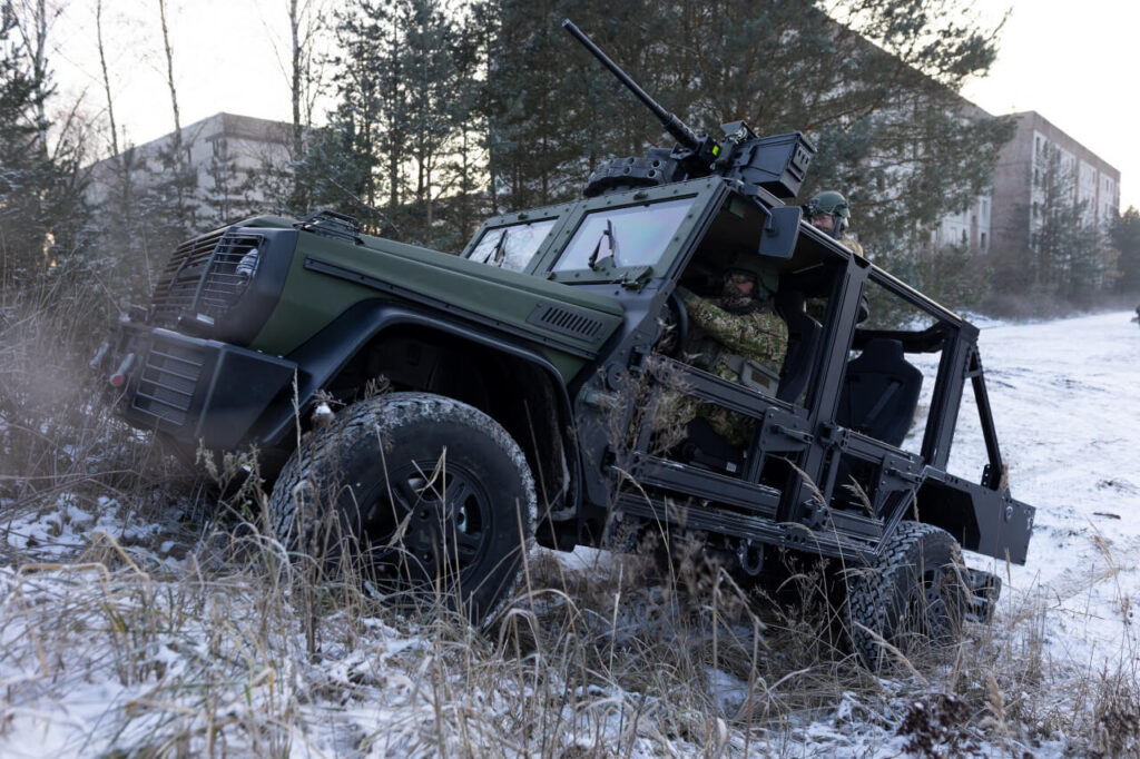 A Caracal light air assault vehicle is driving up a hill in winter during a demonstration by Rheinmetall